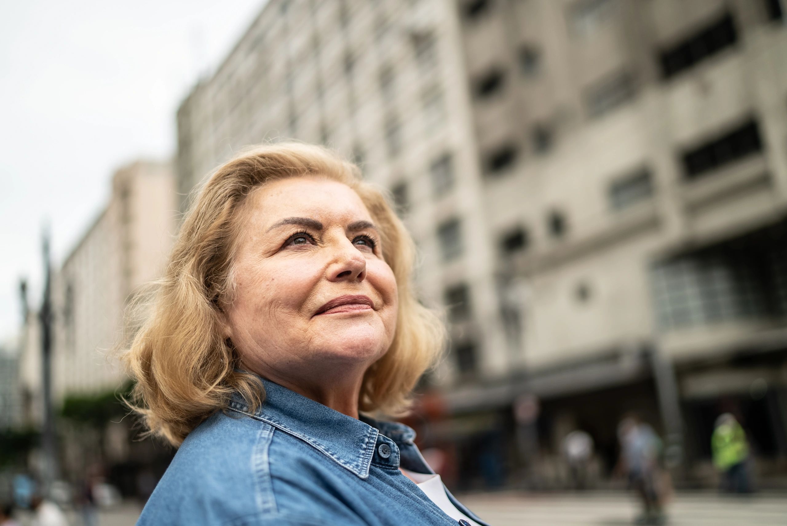 Thoughtful woman outdoors representing reflection, vitality, and healthy longevity